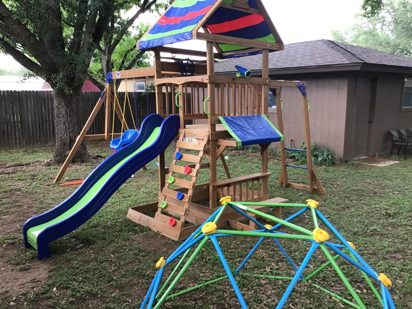 Backyard Discovery Beach Front Cedar Wood Swing Set with Wave Slide, Play Deck, Monkey Bars, Rock Wall Ladder, Shaded Picnic Area, Snack Bar, Belt Swings, Trapeze, Sandbox Area, Outdoor Playset customer photo 1